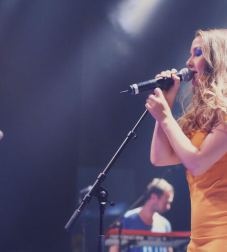 Enjoying every second in the music industry. A band playing on stage at a concert. A band playing on stage at a concert.